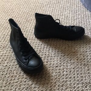 Black high top converse basketball shoe